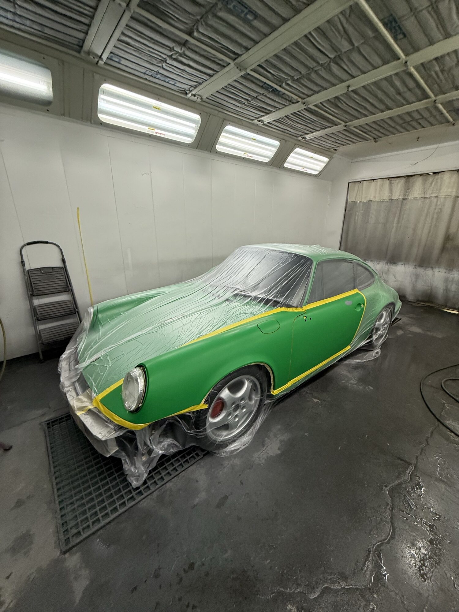 A classic green Porsche 911 masked and prepped in the Alpina paint booth
